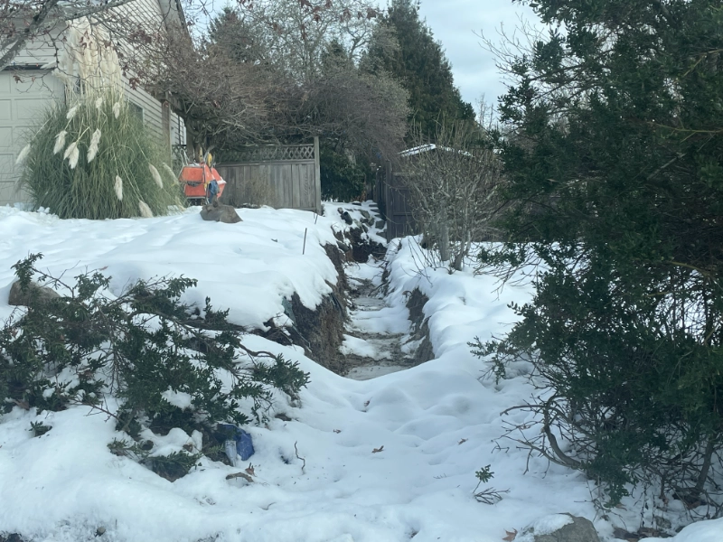 An excavated trench that has been filled with snow and ice due to a recent snow storm