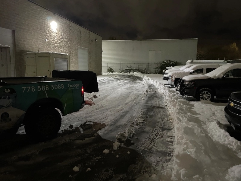 atkinson truck back end showing phone number 778 588 5088 as it plows a parking lot